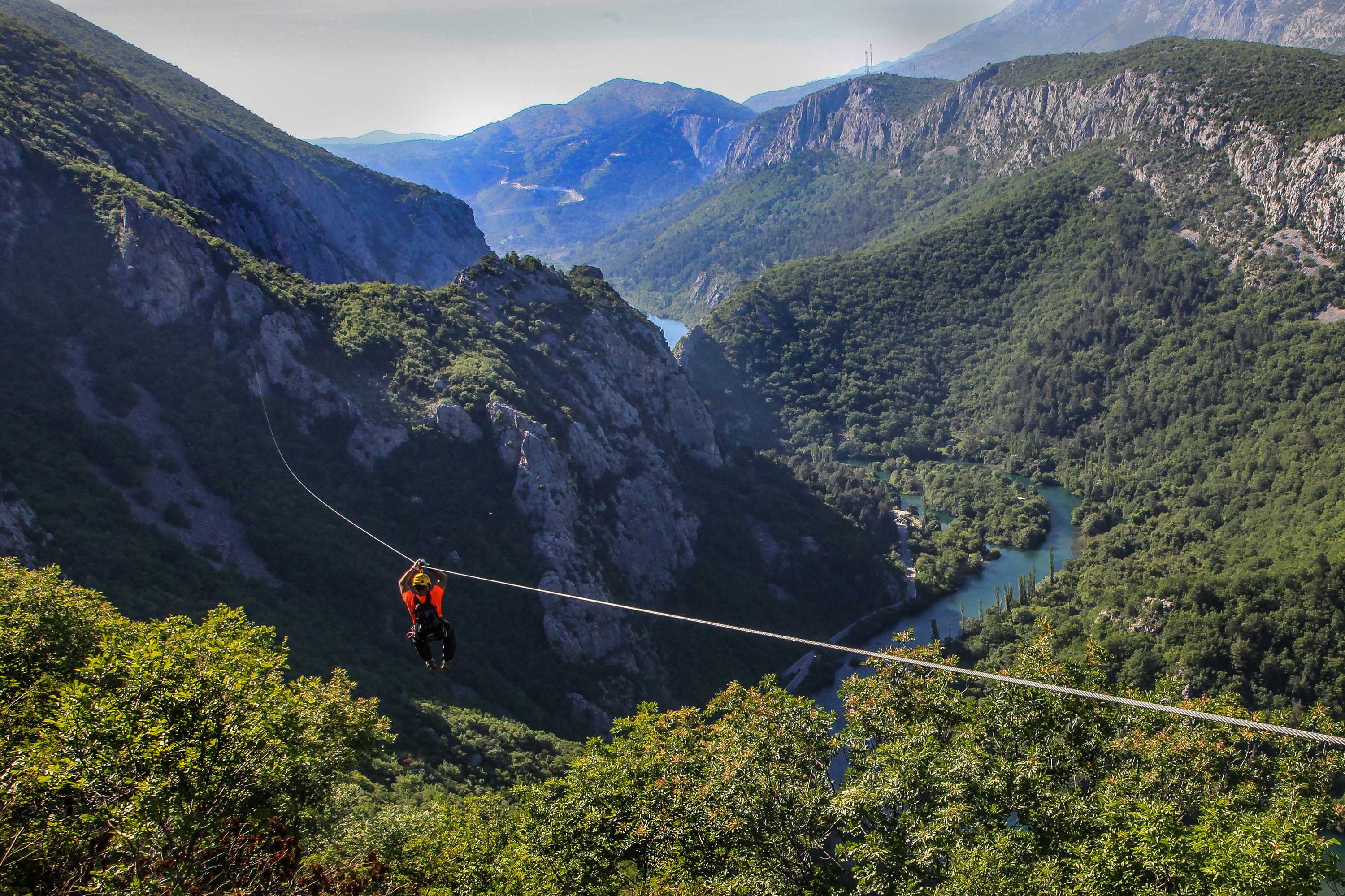 Zipline rider crossing the Cetina canyon, Omiš, Croatia